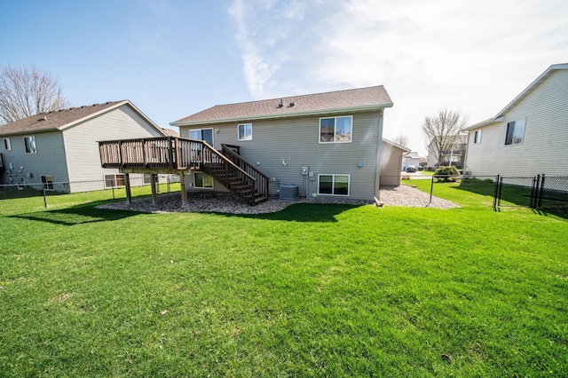back of property featuring a lawn, a wooden deck, central AC unit, stairway, and a fenced backyard