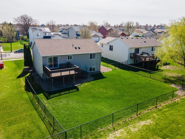 back of property featuring fence, a residential view, and a deck