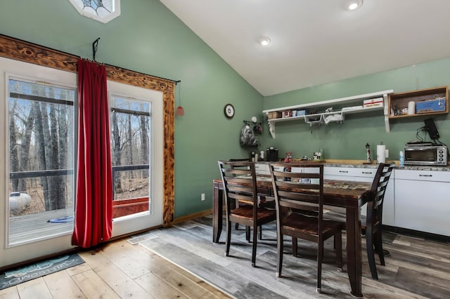 dining room featuring recessed lighting, a toaster, wood finished floors, and lofted ceiling