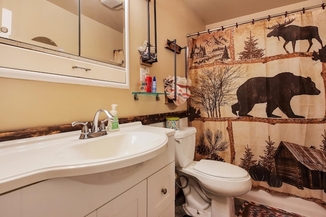 bathroom with a shower with shower curtain, vanity, and toilet