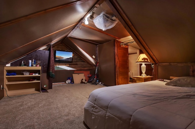 carpeted bedroom featuring wood walls and lofted ceiling