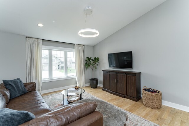 4594 Buckingham Dr NW, Rochester, MN 55901 - living area with lofted ceiling, baseboards, light wood-style floors, and recessed lighting