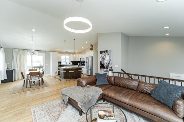 4594 Buckingham Dr NW, Rochester, MN 55901 - living area with light wood-style flooring, lofted ceiling, and recessed lighting