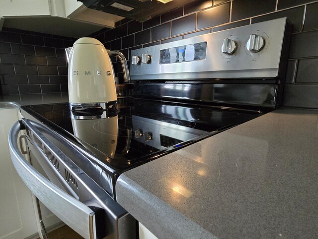 4594 Buckingham Dr NW, Rochester, MN 55901 - kitchen view of stainless steel electric range and decorative backsplash