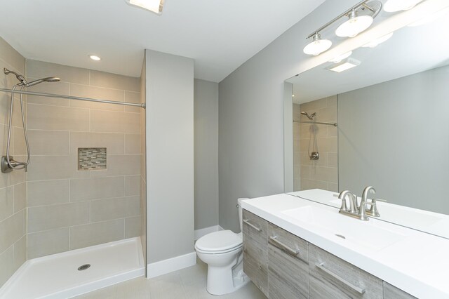 4594 Buckingham Dr NW, Rochester, MN 55901 - full bathroom featuring toilet, vanity, tiled shower, tile patterned flooring, and recessed lighting