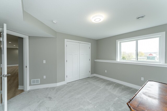 4594 Buckingham Dr NW, Rochester, MN 55901 - unfurnished bedroom with carpet, baseboards, and a closet