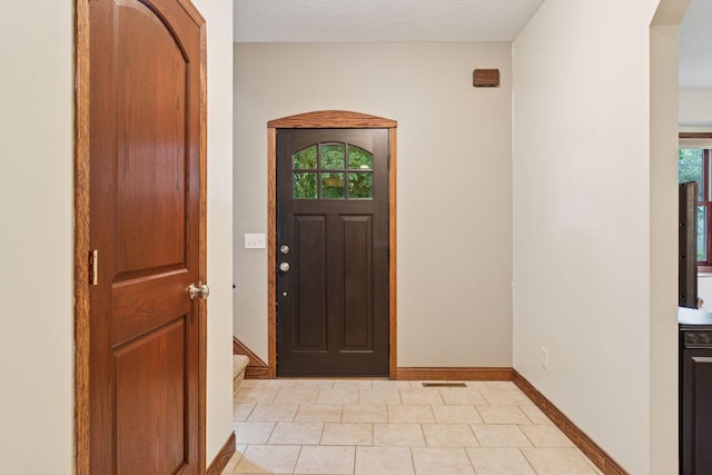 1584 Merrill St, Saint Paul, MN 55108 - entryway with arched walkways and light tile patterned floors