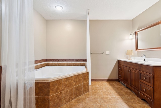 1584 Merrill St, Saint Paul, MN 55108 - full bathroom featuring vanity, a garden tub, and a textured ceiling