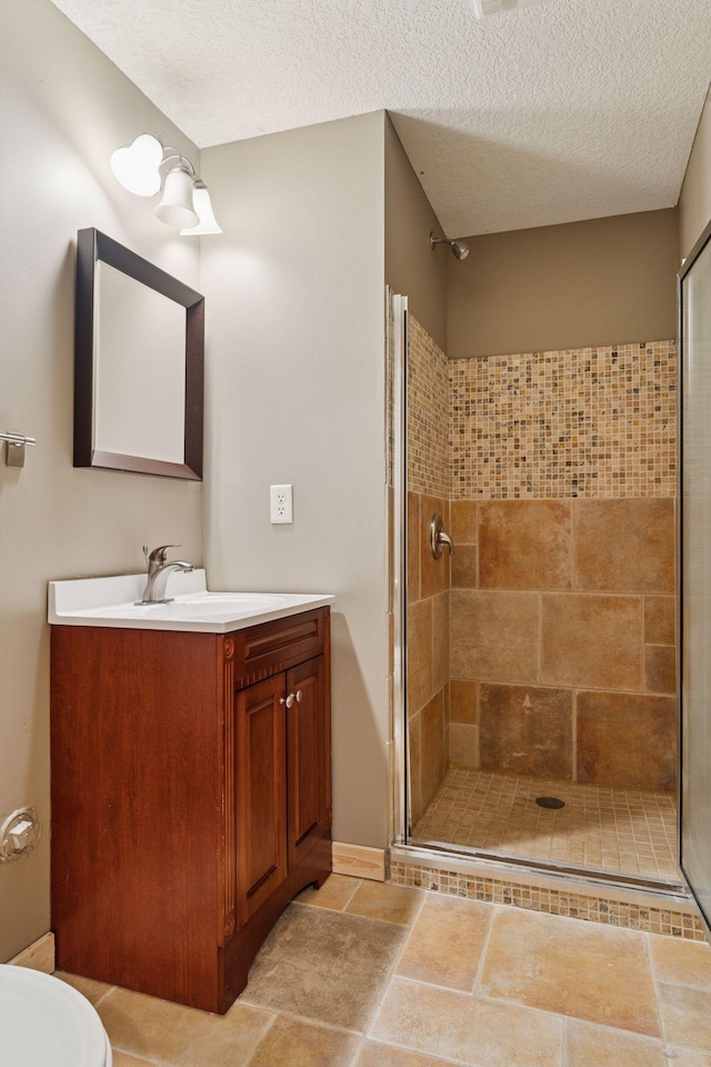 1584 Merrill St, Saint Paul, MN 55108 - bathroom with a stall shower, vanity, and a textured ceiling