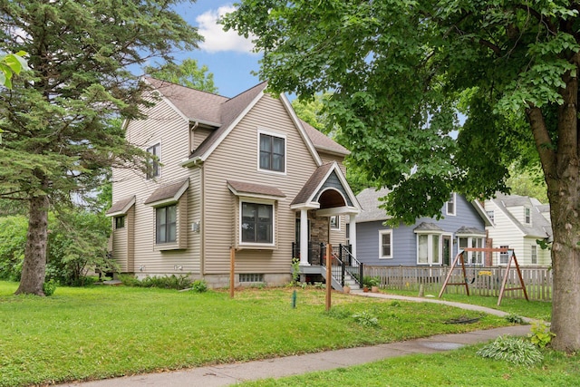 1584 Merrill St, Saint Paul, MN 55108 - view of front facade featuring a shingled roof and a playground