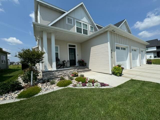 8825 Meadowlark Pkwy, Horace, ND 58047 - view of front of home featuring board and batten siding, an attached garage, covered porch, and concrete driveway
