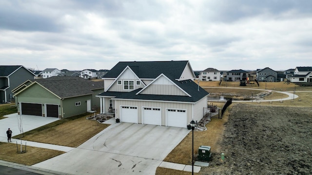 8825 Meadowlark Pkwy, Horace, ND 58047 - view of front of house with concrete driveway, a residential view, board and batten siding, a garage, and a shingled roof