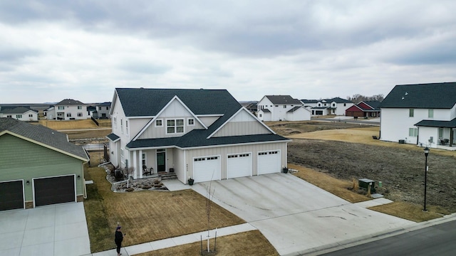 8825 Meadowlark Pkwy, Horace, ND 58047 - view of front of house with board and batten siding, a residential view, and concrete driveway