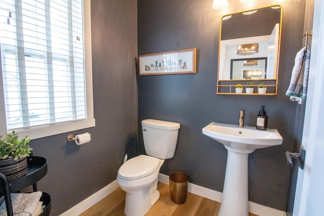 8825 Meadowlark Pkwy, Horace, ND 58047 - half bath featuring toilet, wood finished floors, and baseboards