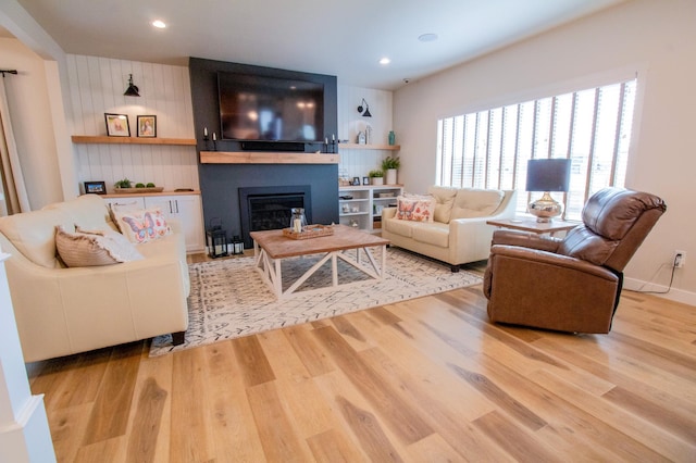 8825 Meadowlark Pkwy, Horace, ND 58047 - living area featuring wood finished floors, a fireplace, and recessed lighting