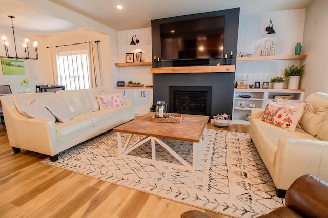 8825 Meadowlark Pkwy, Horace, ND 58047 - living area with a chandelier, wood finished floors, a fireplace, and recessed lighting