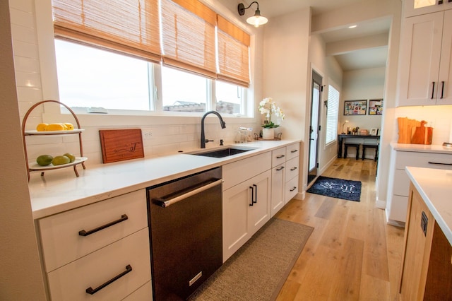 8825 Meadowlark Pkwy, Horace, ND 58047 - kitchen featuring tasteful backsplash, white cabinetry, dishwasher, a sink, and light wood finished floors