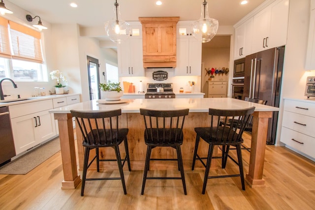8825 Meadowlark Pkwy, Horace, ND 58047 - kitchen with tasteful backsplash, light countertops, a center island, appliances with stainless steel finishes, and a sink
