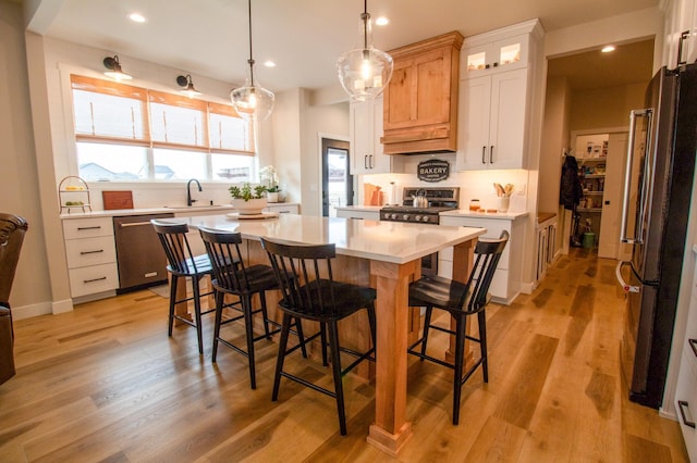 8825 Meadowlark Pkwy, Horace, ND 58047 - kitchen featuring a center island, a sink, appliances with stainless steel finishes, recessed lighting, and decorative backsplash