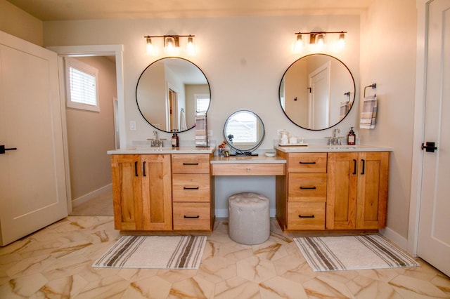8825 Meadowlark Pkwy, Horace, ND 58047 - bathroom with two vanities, marble finish floor, a sink, and baseboards