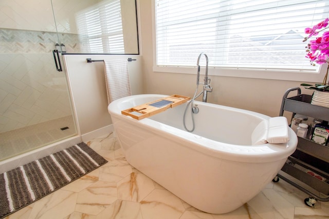 8825 Meadowlark Pkwy, Horace, ND 58047 - full bath featuring a shower stall, a freestanding tub, and marble finish floor