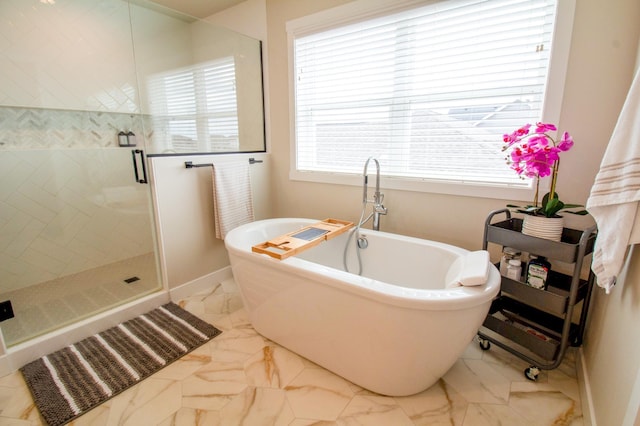 8825 Meadowlark Pkwy, Horace, ND 58047 - bathroom featuring a soaking tub, baseboards, marble finish floor, and a stall shower