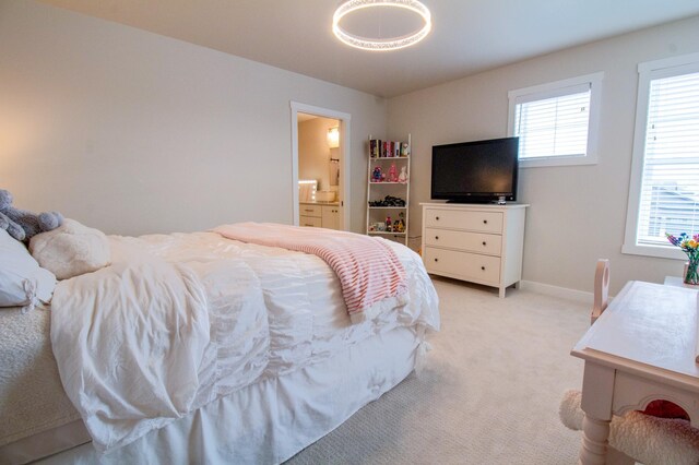 8825 Meadowlark Pkwy, Horace, ND 58047 - bedroom with baseboards, connected bathroom, and light carpet