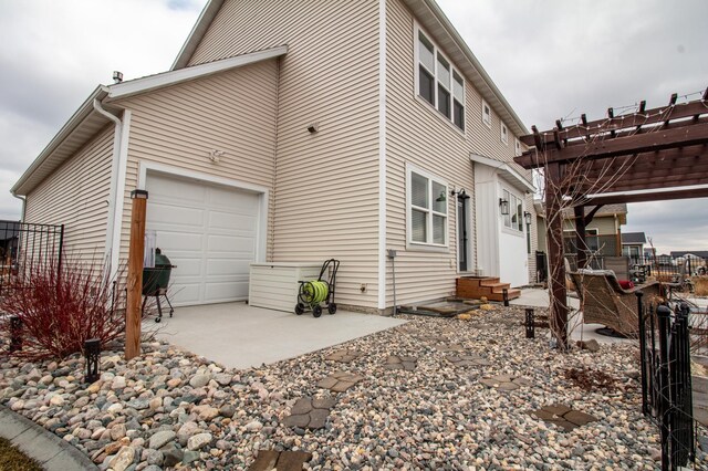 8825 Meadowlark Pkwy, Horace, ND 58047 - view of home's exterior featuring entry steps, fence, a garage, and a pergola