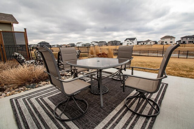 8825 Meadowlark Pkwy, Horace, ND 58047 - view of patio with a residential view, fence, and outdoor dining area