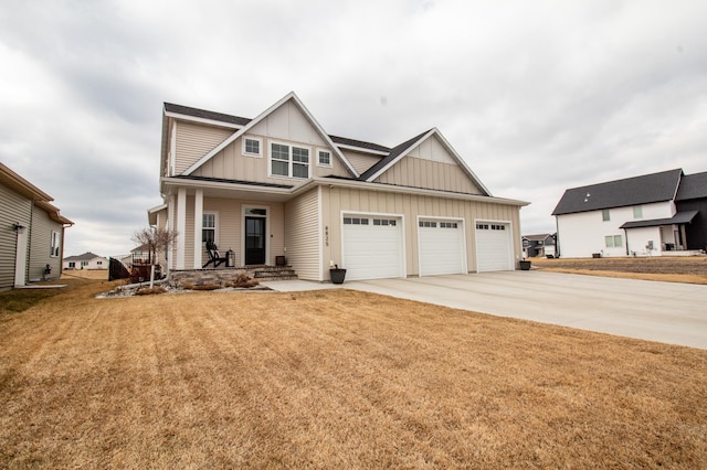 8825 Meadowlark Pkwy, Horace, ND 58047 - craftsman-style home featuring board and batten siding, a porch, a front yard, an attached garage, and driveway