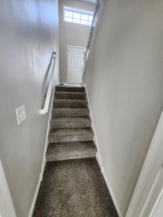 staircase featuring baseboards