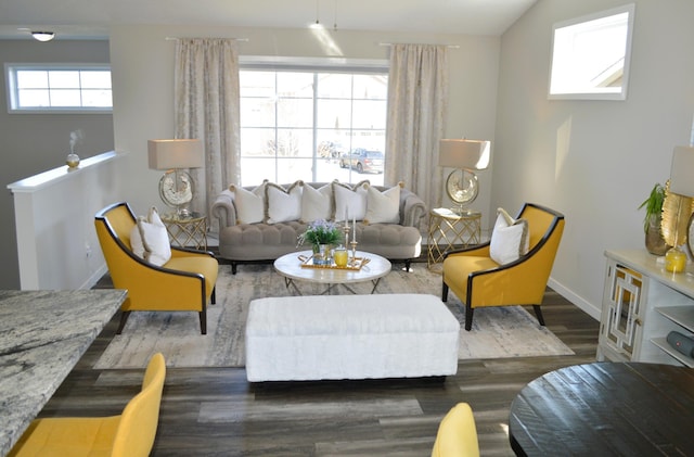 living area with baseboards and wood finished floors