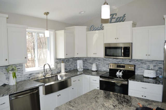 kitchen featuring stainless steel appliances, white cabinetry, a sink, and tasteful backsplash