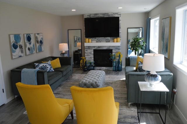 living area with a healthy amount of sunlight, a fireplace, and wood finished floors