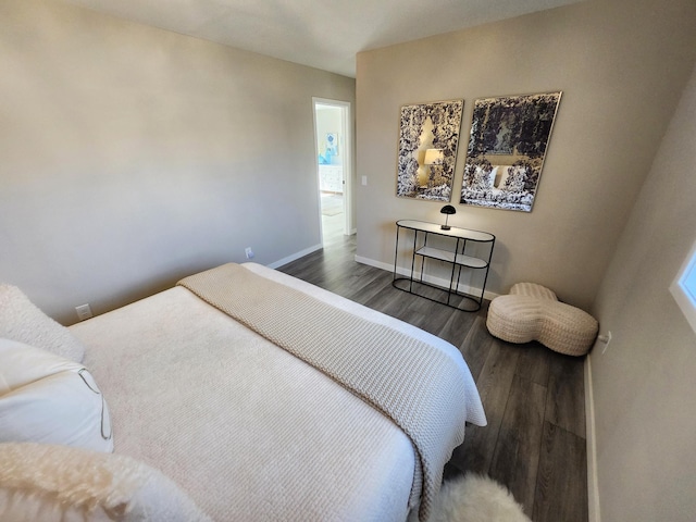 bedroom featuring baseboards and wood finished floors