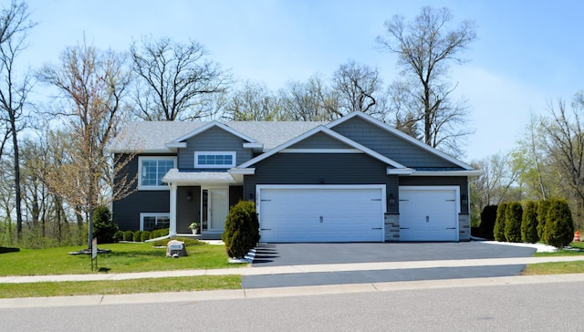 view of front of property with a garage, driveway, and a front yard