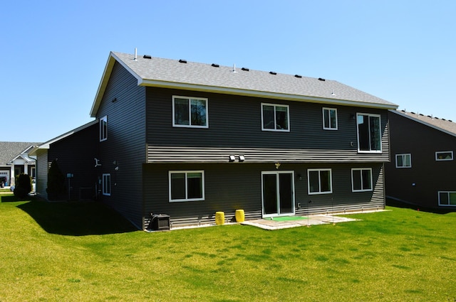 back of house with a patio and a yard