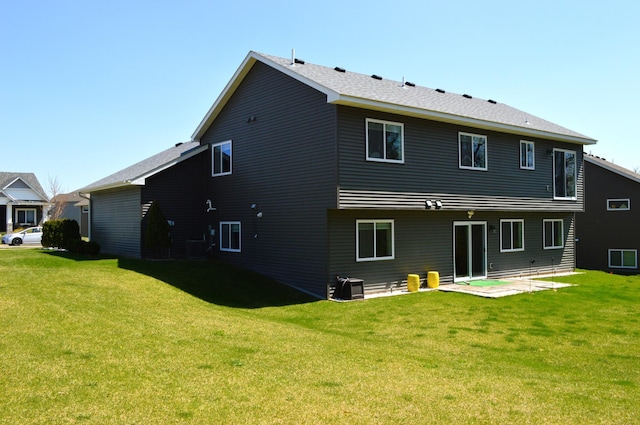 rear view of property with a lawn and a patio area