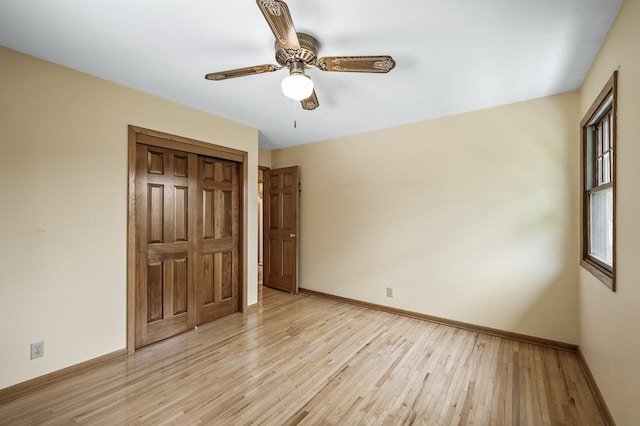 2235 Chestnut Rd, Medina, MN 55340 - unfurnished bedroom featuring light wood-style floors, baseboards, a ceiling fan, and a closet