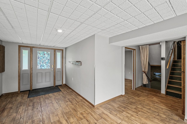 2235 Chestnut Rd, Medina, MN 55340 - foyer entrance with light wood finished floors, stairway, and baseboards