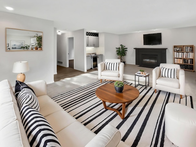 7426 Chesham Ln, Woodbury, MN 55125 - living room featuring baseboards, a glass covered fireplace, and visible vents