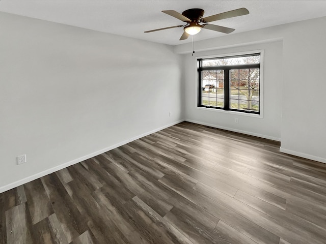 7426 Chesham Ln, Woodbury, MN 55125 - empty room with ceiling fan, baseboards, and dark wood-style flooring