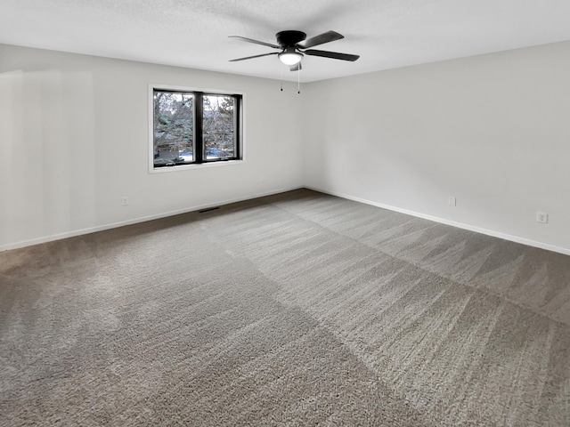 7426 Chesham Ln, Woodbury, MN 55125 - carpeted empty room featuring baseboards, a ceiling fan, and visible vents