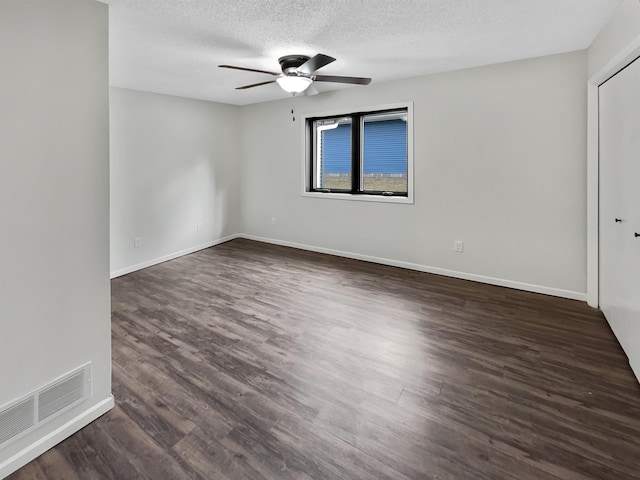 7426 Chesham Ln, Woodbury, MN 55125 - interior space featuring baseboards, dark wood finished floors, a textured ceiling, visible vents, and ceiling fan