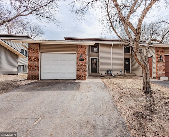 5401 70th Cir N, Brooklyn Center, MN 55429 - view of front facade featuring driveway and a garage