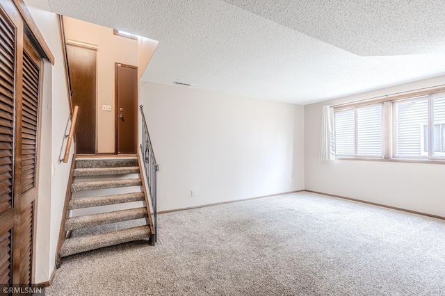 5401 70th Cir N, Brooklyn Center, MN 55429 - stairway with carpet flooring and a textured ceiling