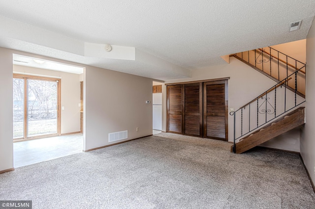 5401 70th Cir N, Brooklyn Center, MN 55429 - unfurnished living room featuring carpet flooring, stairway, and a textured ceiling