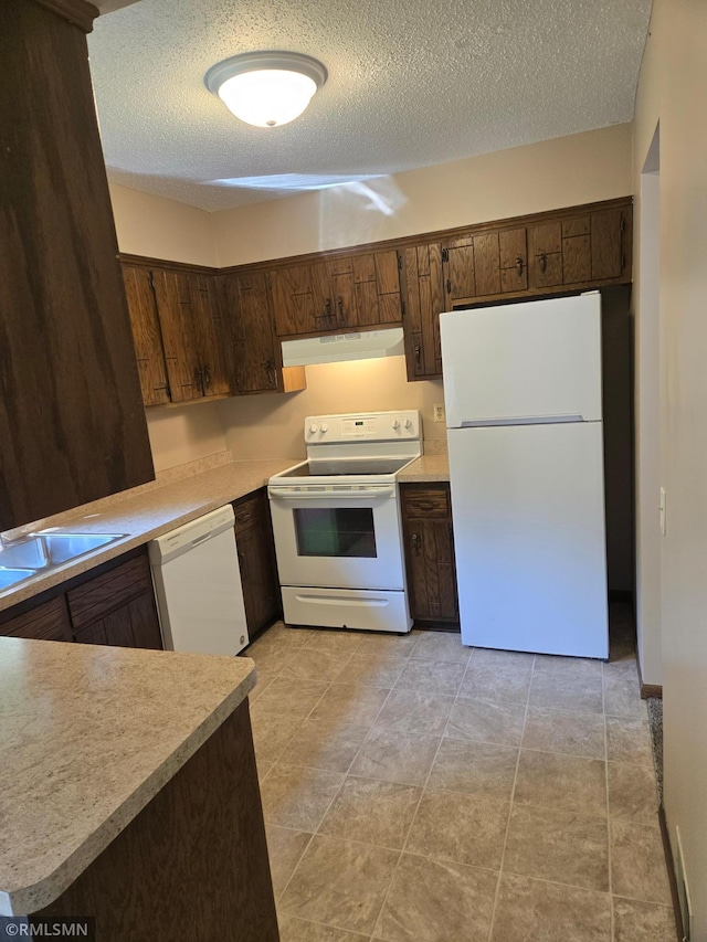5401 70th Cir N, Brooklyn Center, MN 55429 - kitchen with white appliances, under cabinet range hood, a textured ceiling, light countertops, and dark brown cabinetry