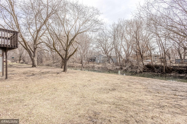 5401 70th Cir N, Brooklyn Center, MN 55429 - view of yard with a deck with water view
