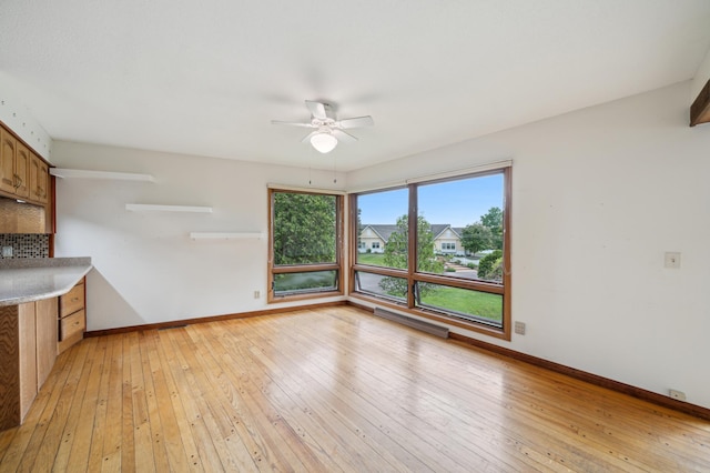 1615 2nd St N, Stillwater, MN 55082 - unfurnished living room featuring ceiling fan, baseboards, and light wood-style floors